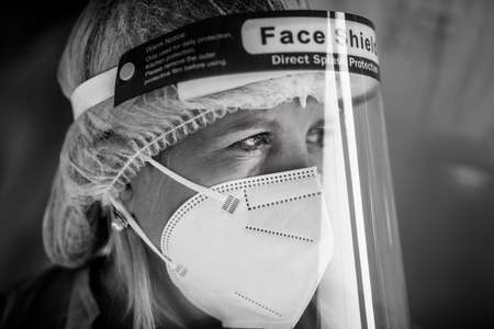 Bucharest, Romania - September 4, 2021: Portrait of a caucasian female medical worker in a Covid-19 vaccination center.のeditorial素材