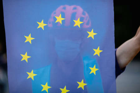 Bucharest, Romania - September 4, 2021: A man holds an European Union flag during an anti-government protest in Bucharest.のeditorial素材