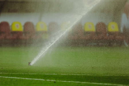 Details with lawn sprinklers on the pitch of a soccer stadium.の写真素材