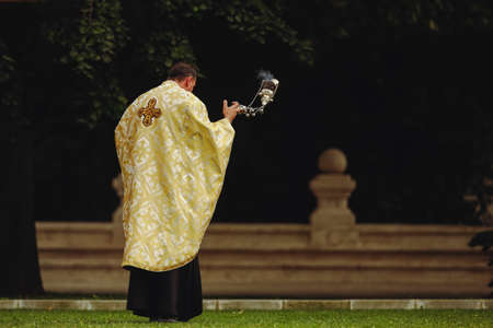 Bucharest, Romania - September 13, 2021: A Romanian Orthodox priest during an outdoor religious ceremony.のeditorial素材