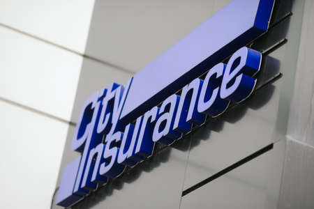Bucharest, Romania - September 23, 2021: Shallow depth of field (selective focus) image with City Insurance logo on the building HQ in Bucharest.のeditorial素材