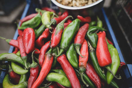 Shallow depth of field (selective focus) image with hot red and green peppers sold by a Romanian man...