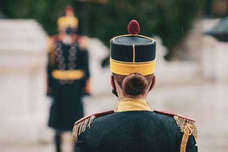 Bucharest, Romania - 23 November, 2021: Shallow depth of field (selective focus) image with Michael the Brave 30th Guards Brigade female soldier during a ceremony on a rainy day.のeditorial素材
