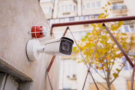 Details with a CCTV camera on a wall outside a building.