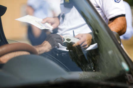 Highway 2 Bucharest - Constanta, Romania - 10 August, 2021: Romanian Road Police officer hands a breathalyser to a driver to test his alcohol level.のeditorial素材