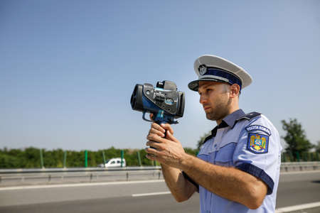 Highway 2 Bucharest - Constanta, Romania - 10 August, 2021: Romanian Road Police officer uses a...