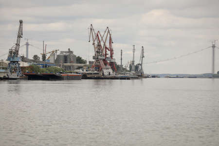 Braila, Romania - August 26, 2021: Details with cranes and ships in the shipyard and on the docks of...
