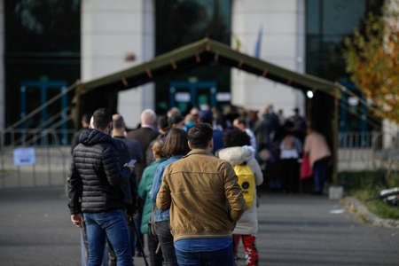 Bucharest, Romania - October 23, 2021: People queue to get an anti COVID-19 vaccine during a...