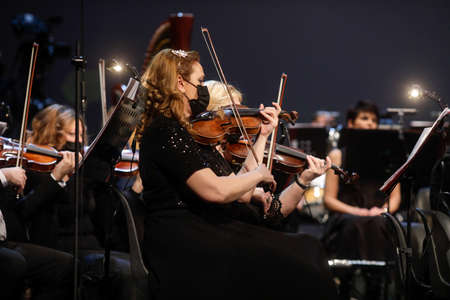 Bucharest, Romania - January 15, 2022: Members of a classical music orchestra perform during an...