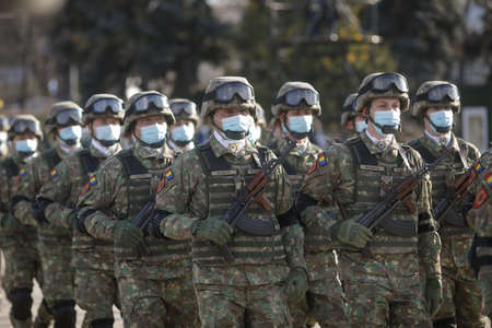 Bucharest, Romania - January 24, 2022: Details with Romanian soldiers holding AK 47 automatic rifles...