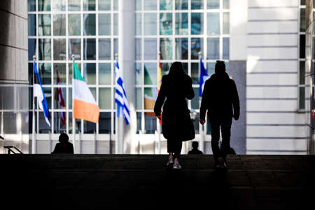 Brussels, Belgium - March 25, 2021: Silhouettes of people walking in the  European Parliament building in Brussels.のeditorial素材