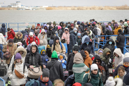 Isaccea, Romania - March 4, 2022: Ukrainian refugees, mostly women and children, flee the war in...