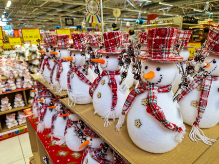 Bucharest, Romania - October 30, 2022: Shallow depth of field (selective focus) details with Christmas decorations (snowmen) for sale in a specialised hipermarket.のeditorial素材