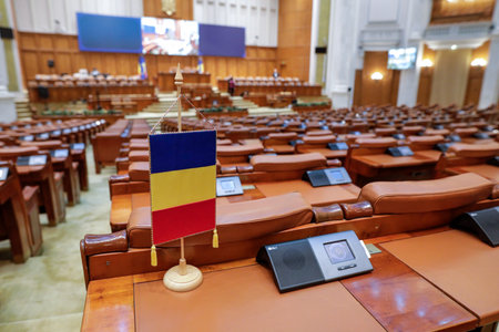 Bucharest, Romania - November 14, 2022: Romanian flag and empty seats in the Romanian Chamber of Deputies inside the Palace of Parliament.のeditorial素材