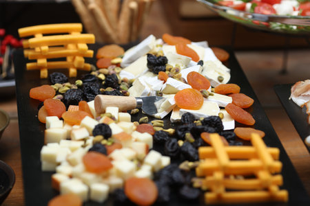 Shallow depth of field (selective focus) details with various types of cheese at a buffet.の写真素材