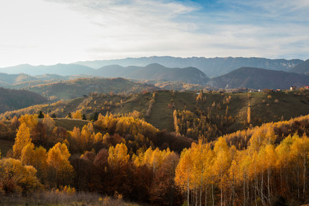 Scenic autumn overview of Magura village in Romania, near the Piatra Craiului mountains.の写真素材