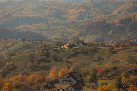Scenic autumn overview of Magura village in Romania, near the Piatra Craiului mountains.
