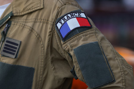 Shallow depth of field (selective focus) details with the French flag on the flight suit of a french pilotの写真素材
