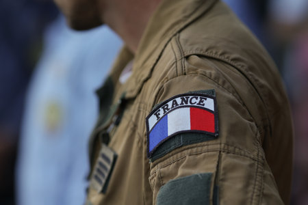 Shallow depth of field (selective focus) details with the French flag on the flight suit of a french pilotの写真素材