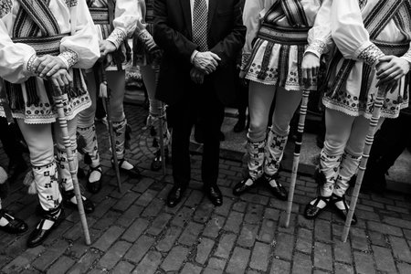 Man in suit next to  Calusari, ancient Romanian traditional dancers.の写真素材
