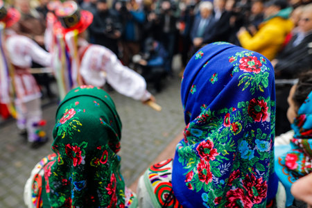 Details with the traditional clothes and general outfit of a woman and her young daughter.