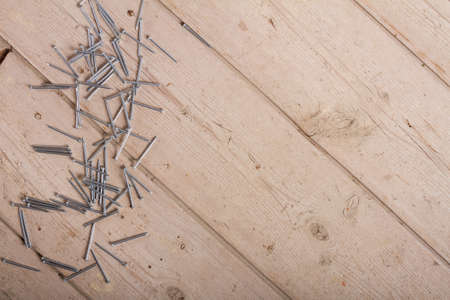 wooden hardware nails on rough surface and isolated on white backgroundの写真素材