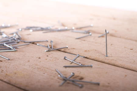 wooden hardware nails on rough surface and isolated on white backgroundの写真素材