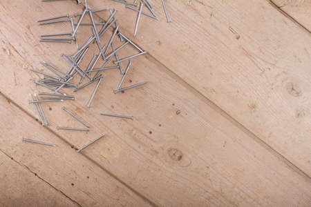 wooden hardware nails on rough surface and isolated on white backgroundの写真素材