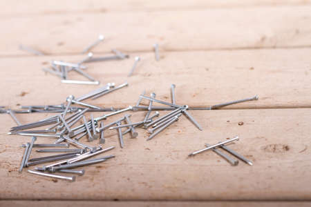 wooden hardware nails on rough surface and isolated on white backgroundの写真素材