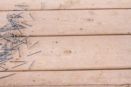 wooden hardware nails on rough surface and isolated on white backgroundの写真素材