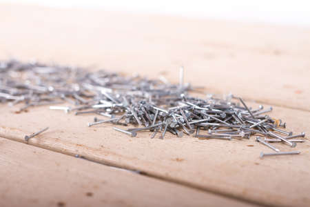 wooden hardware nails on rough surface and isolated on white backgroundの写真素材