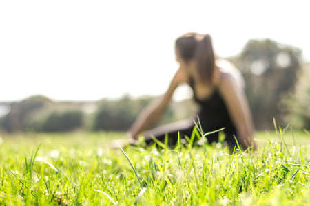 Young athletic woman practicing hatha yoga postures wearing leggings and pigtailの写真素材