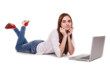 Happy girl with PC on floor - Stock Imageの写真素材