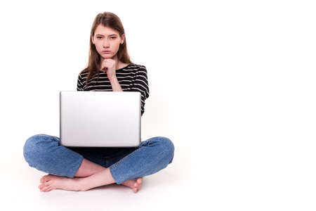 Young Woman with PC hand on chin E-commerce Stock Imageの写真素材