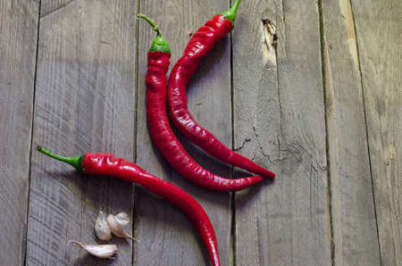 Red hot chili peppers on old wooden table groupの写真素材