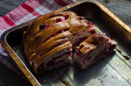 Homemade pie on grey wooden background with napkinの写真素材