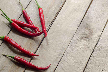 Red chili on an old wooden background.の写真素材