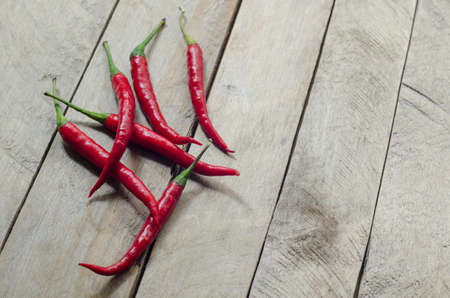 Red chili on an old wooden background.の写真素材