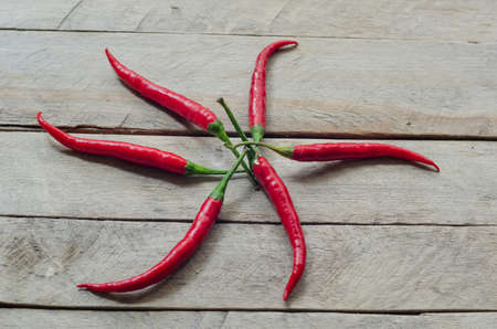 Red chili on an old wooden background.の写真素材