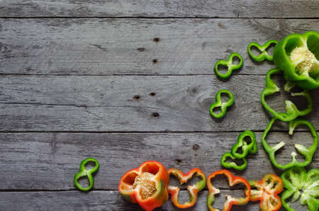 Photo of sliced colorul peppers over wooden tableの写真素材