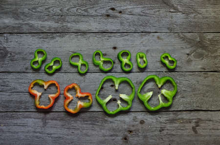Photo of sliced colorul peppers over wooden table