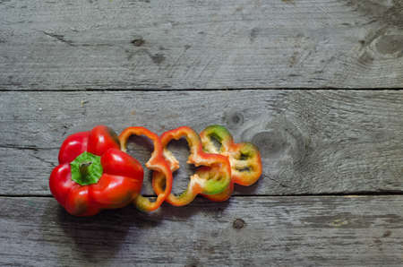 Photo of sliced colorul peppers over wooden tableの写真素材
