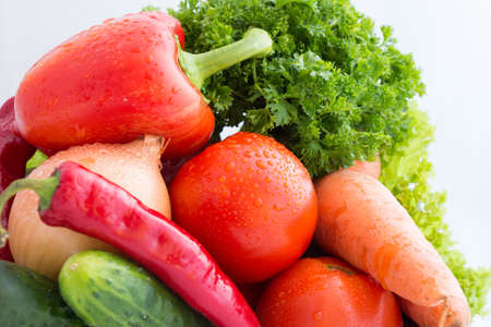Fresh vegetables in basket on  wooden tableの写真素材