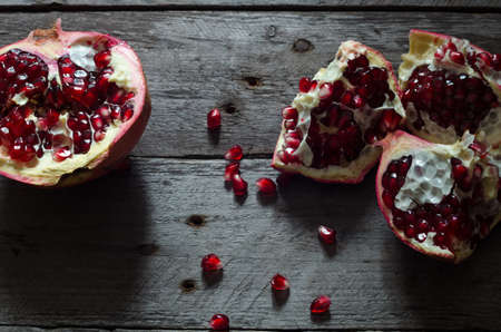 Ripe pomegranate fruit on wooden vintage backgroundの写真素材