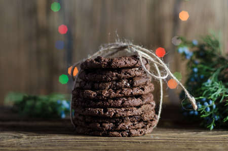 A photo of freshly baked chocolate chips cookies with glass of milkの写真素材