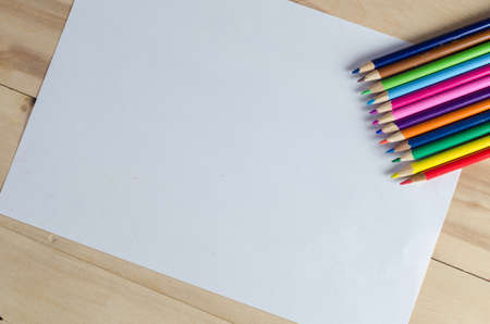 color pencils on white paper on the table. View from aboveの写真素材