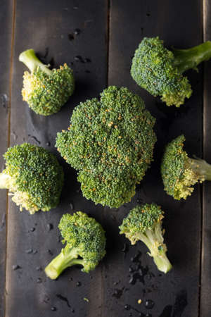 Broccoli on black wooden backgroundの写真素材