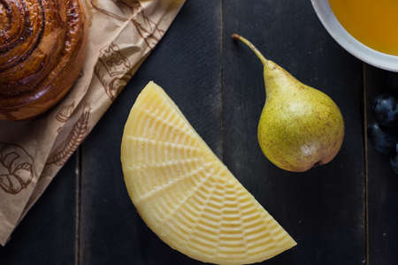Morning breakfast. Bun, cheese, swet honey and fruits. Homemade traditional foodの写真素材