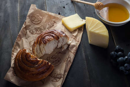 Morning breakfast. Bun, cheese, swet honey and fruits. Homemade traditional foodの写真素材