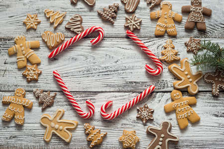 Christmas cookie and candy on wood, food top view. Gifts with craft paer. Text.の写真素材